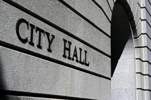 Image is a close up of a city hall building in black and white.