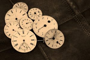 Image is of vintage clock faces.