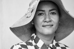 Image is of a Cambodian woman wearing a hat.