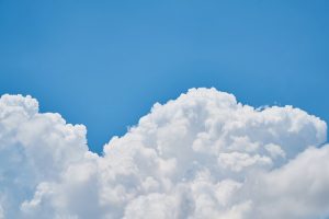 Image is of white clouds against a blue sky.