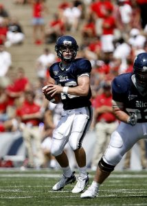 Image is of a high school football quarterback in the middle of a play.