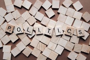 Image is of scrabble tiles spelling the word Politics.
