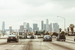Image is of Los Angeles traffic against the Los Angeles skyline.