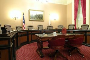 Image is of a committee meeting room in the California Capital Building.