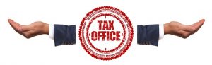 Image is of a seal with the words "Tax Office" inside, flanked by two outstretched hands.