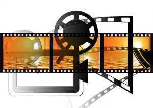 Image is an illustration of a film projector and film.
