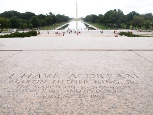 Image is a picture overlooking the Washington Monument with the "I have a Dream" subscription in the foreground.