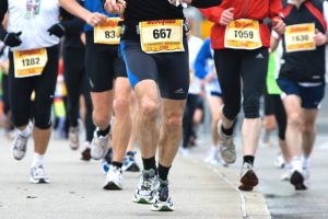 Image is of runners legs' in a marathon.