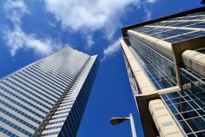 Image is two skyscrapers as seen from the base looking up between them.