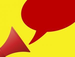 Image is a red megaphone with speech bubble against a yellow background.