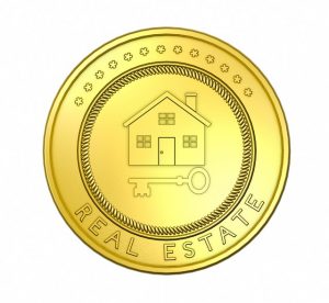 Image is a gold coin with a house and key on it and the words Real Estate.