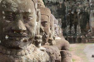 Image is a close up of statues in Angkor Wat in Cambodia.