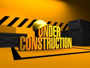 Image is an Under Construction sign in yellow and black.
