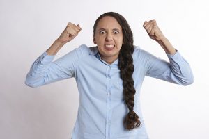 Image is of an angry woman against a white background.
