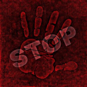 Image is a handprint with the word stop stamped over the top of it, with everything in shades of red.