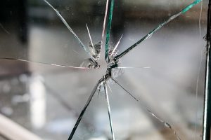 Image is a close up of a broken window.