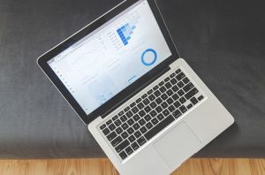 Image is an open laptop with a graph and stats on it.