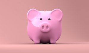 Image is pink piggy bank against a pink background.