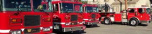 Image is a line of Culver City Fire Department fire trucks.