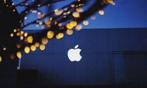 Image is the outside of an Apple building, with the Apple logo.