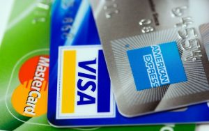Image is a close up of a Mastercard, Visa, and American Express credit card.