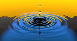 Image is a drop of water in a pool creating ripples.