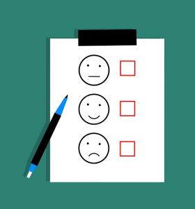 Image is a sheet of paper with a smiley face, neutral face, and a frowny face on it, each with a check box next to it.
