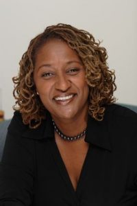 Image is Sen. Holly J. Mitchell with a protective hairstyle