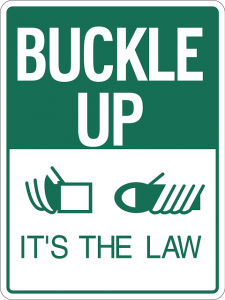 Image is a Buckle Up It's the Law sign.