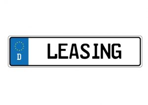 Image is a black and white sign that reads "leasing".