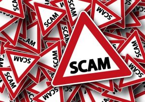 Image is an illustration of a bunch of roads signs in a pile with the word scam on each one.