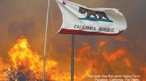 California Stat Flag flies amid raging fire in Paradise California.  