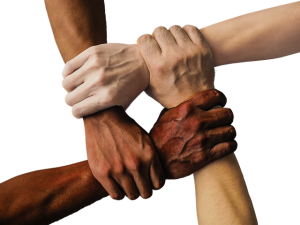 Image is four people of different nationalities gripping wrists to form a square.