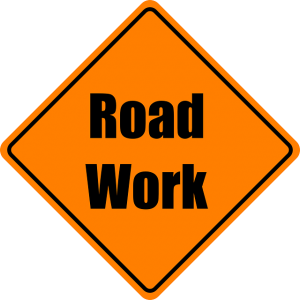Image is a yellow road sign that says "road work."