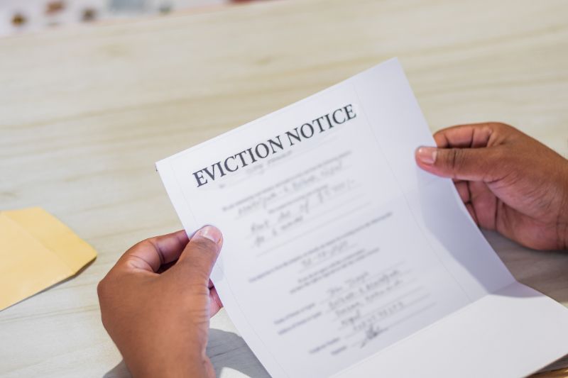 hands of a man holds eviction notice letter